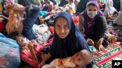 Ethnic Rohingya refugees sit at a temporary shelter in North Aceh, Indonesia, Nov. 15, 2022. 