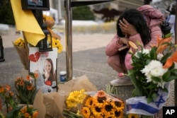 A woman mourns at a memorial for deceased hostages Shiri Bibas, her two children, Ariel and Kfir, and Oded Lifshitz at “Hostages Square,” while Israelis gather while waiting for the release of six hostages in Gaza, in Tel Aviv, Israel, Feb. 22, 2025.