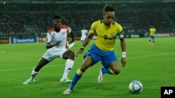 Le capitaine gabonais Pierre Aubameyang, à droite, amorce un drible devant le Burkinabé Steeve Yago lors d’un match de la phase finale de la Coupe d’Afrique des nations entre le Gabon et le Burkina à Bata, Guinée équatoriale, 17 janvier 2015.