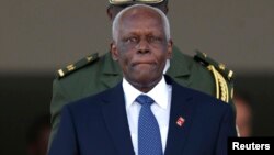 Gold medal winner Brianna Rollins, silver medal winner, Nia Ali, and bronze medal winner Kristi Castlin,all from the United States, celebrate with their country's flag.