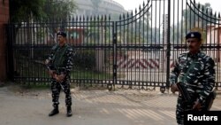 FILE - Security force personnel stand guard outside the parliament premises after a man jumped into the lawmakers' area of the lower house of India's parliament, in New Delhi, India, Dec. 13, 2023. 