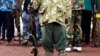 FILE - A former child soldier poses with his gun in this undated photo.