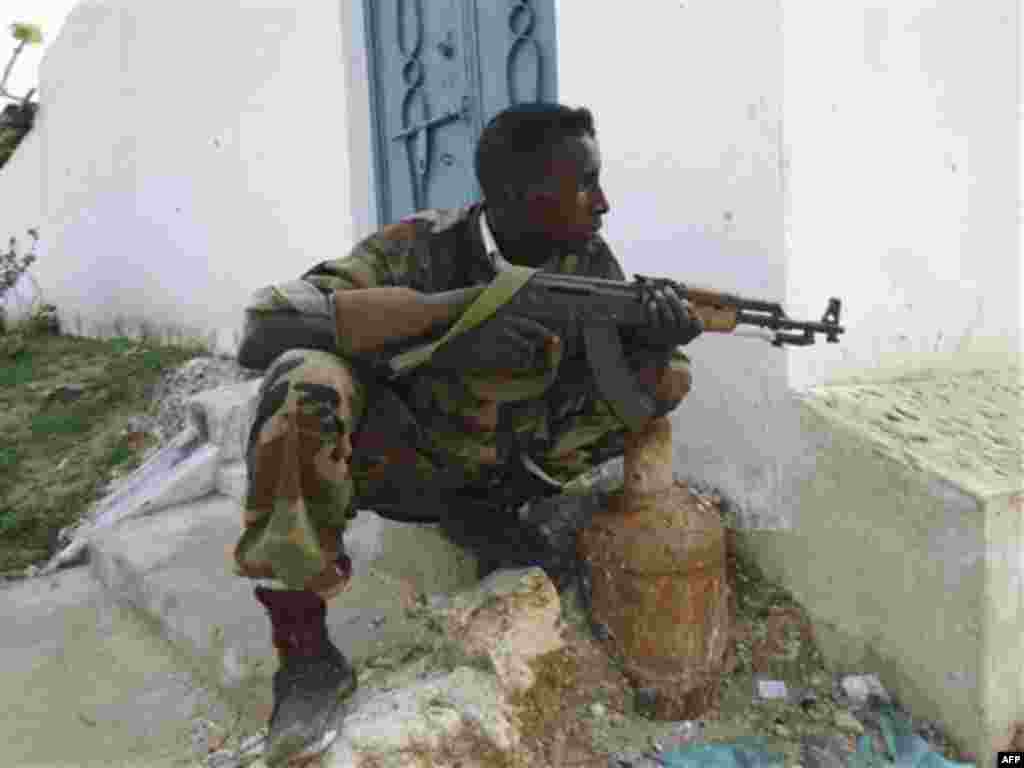 A Somalia Transitional Government soldier in Yaaqshid district in Mogadishu, Somalia, Saturday, Aug. 6, 2011, after rebel fighters withdrew from their positions in the capital. Islamist fighters withdrew overnight from almost all their bases in the famin