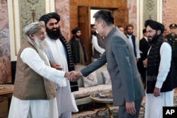 FILE - In this photo released by the Taliban, China's new ambassador to Afghanistan, Zhao Sheng, shakes hand with Taliban Prime Minister Mohammad Hasan Akhund in Kabul, Afghanistan, Sept. 13, 2023. China is one of two countries that have formally accepted a Taliban ambassador.