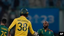 FILE - South Africa's captain Temba Bavuma shakes hand with Australia's Josh Hazlewood after South Africa won the ICC Cricket World Cup match against Australia in Lucknow, India, Thursday, Oct. 12, 2023.