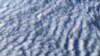 This picture taken from a plane shows wind turbines through stratocumulus clouds over Germany on December 7, 2021. 