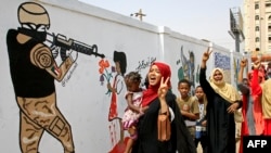 Female Sudanese demonstraters celebrate in Khartoum Aug. 4, 2019, after Sudan's army rulers and protest leaders signed a hard-won power-sharing agreement. 