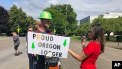 A logger opposed to a cap-and-trade bill is interviewed outside the Oregon State House in Salem, June 20, 2019.