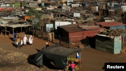 A fruit vendor waits for customers at an informal settlement in Thokoza, south of Johannesburg, South Africa, July 18, 2014. 