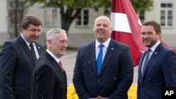 U.S. Secretary of Defense Jim Mattis greets Lithuania's Minister of Defense Raimundas Karoblis, left, Estonia's Minister of Defense Margus Tsahkna, right, and Latvia's Minister of Defense Raimonds Bergmanis, during a meeting in Vilnius, Lithuania, May 10, 2017.