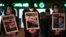 FILE - Protesters hold portraits of victims of the ongoing battles between Israel and Hamas during a rally in support of Palestinians and to demand a ceasefire, in Toulouse, southwestern France, on November 17, 2023.