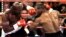 Challenger Mike Tyson (R) and WBA Heavyweight Champion Evander Holyfield mix it up during round one action at the MGM Grand on June 28. Tyson was disqualified in the third round for biting Holyfield on the ear. **DIGITAL IMAGE** - PBEAHUMNKAO