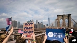 FILE - Pro-gun control demonstrators march across the Brooklyn Bridge in New York, June 14, 2014. The Everytown for Gun Safety advocacy group has part of its roots in New York, having been co-founded by former Mayor Michael Bloomberg.