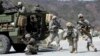 FILE - U.S. Army and South Korean soldiers take their positions during a live-fire exercise at the Rodriquez Multi-Purpose Range Complex in Pocheon, north of Seoul, South Korea, March 25, 2015. 