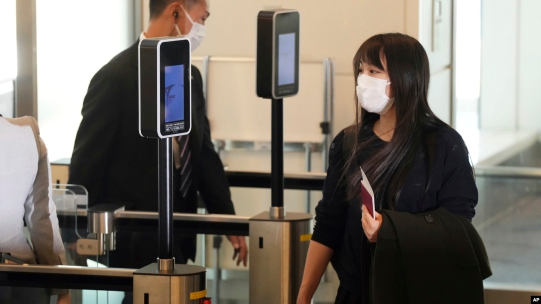 Japan's former Princess Mako, the elder daughter of Crown Prince Akishino, waits for her husband Kei Komuro, not in picture at a boarding gate to board an airplane to New York, Nov. 14, 2021, at Tokyo International Airport in Tokyo.
