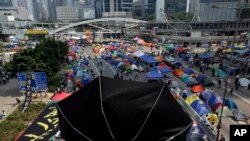 Una sombrilla es colocada cerca de las tiendas en que acampan manifestantes pro-democracia en el centro de Hong Kong.