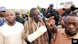 Uganda's Forum for Democratic Change (FDC) leader Kizza Besigye (C) argues with police before his arrest at the Kasangati suburb of the capital Kampala, April 18, 2011. Ugandan opposition leader Besigye was arrested on Monday during a protest against high