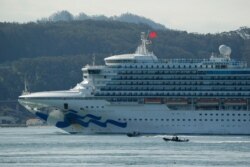 Two boats escort the Grand Princess cruise ship through San Francisco Bay, March 9, 2020.