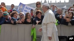 Faithful and tourists reach out to Pope Francis as he arrives for his weekly general audience, in St. Peter's Square at the Vatican, April 6, 2016. (AP Photo/Andrew Medichini)