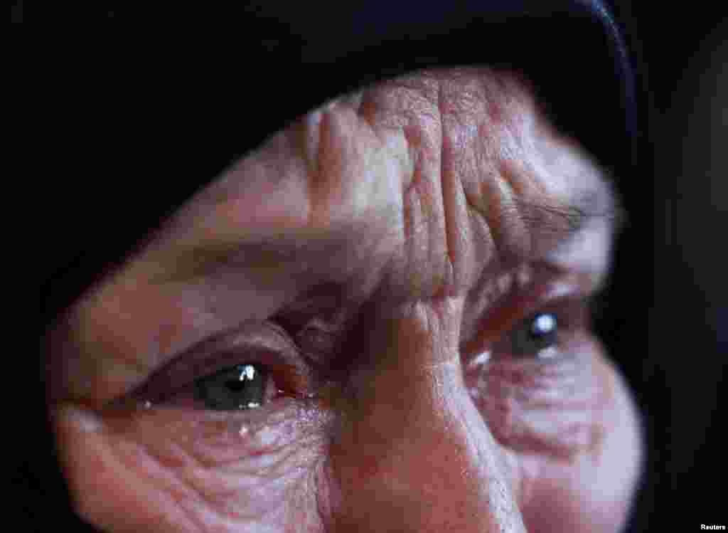 Fayza Hider, whose son was in Sednaya prison since 2013, which was known as a slaughterhouse under Syria&#39;s Bashar al-Assad&#39;s rule, reacts while she searches for her son there, in Sednaya, Dec. 16, 2024.