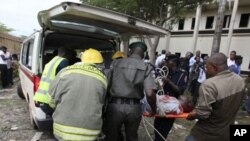 A victim of a bomb blast that ripped through the United Nations offices in the Nigerian capital of Abuja is loaded into an ambulance, August 26, 2011