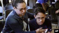Mariela Sanchez, of Honduras, comforts her son, Jonathan, 16, during a news conference, Aug. 26, 2019, in Boston. The Sanchez family came to the U.S. seeking treatment for Jonathan's cystic fibrosis. 