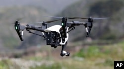 FILE - The Inspire 1, a drone manufactured by DJI, is flown in Davenport, Calif., March 10, 2015. 
