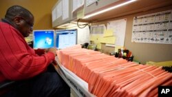 A Fulton County election worker counts provisional ballots in Atlanta, Nov. 7, 2018.