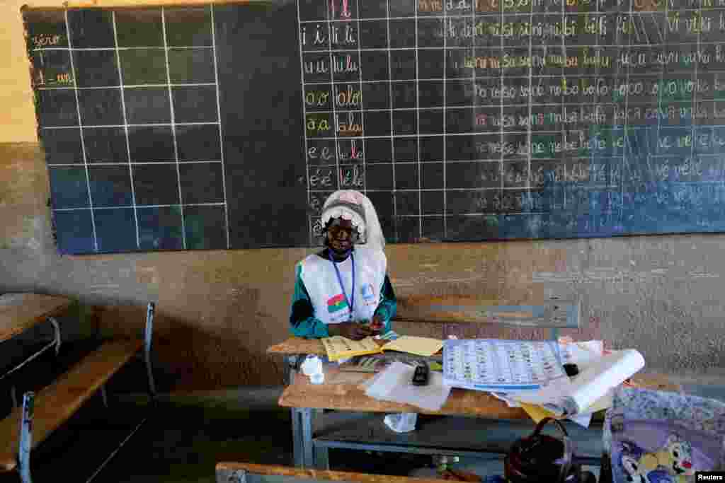 An election employee works during the presidential and legislative elections at a polling station in Ouagadougou, Burkina Faso.