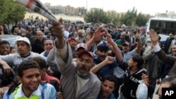 Egyptian protesters shout slogans as they gather to call for the trial of members of ousted President Hosni Mubarak in front of a court in Cairo, Egypt, March 8, 2011