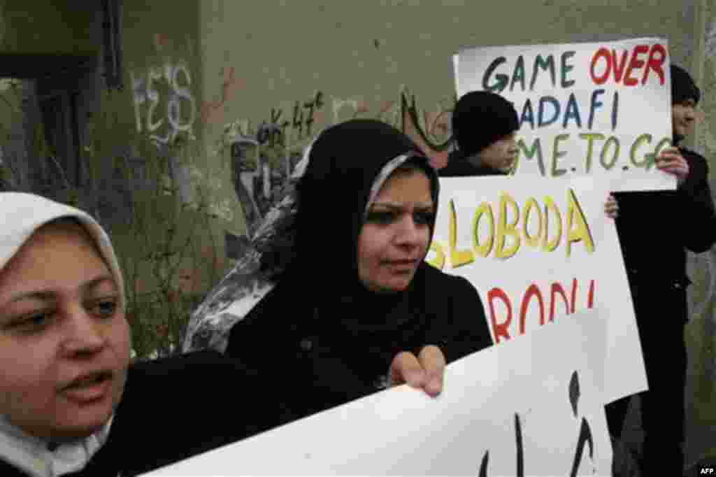 Demonstrators hold placards during a protest in support of Libyan anti-government protestors, in front of the Libyan Embassy, Sarajevo, Bosnia, Wednesday, Feb. 23, 2011. (AP Photo/Sulejman Omerbasic)