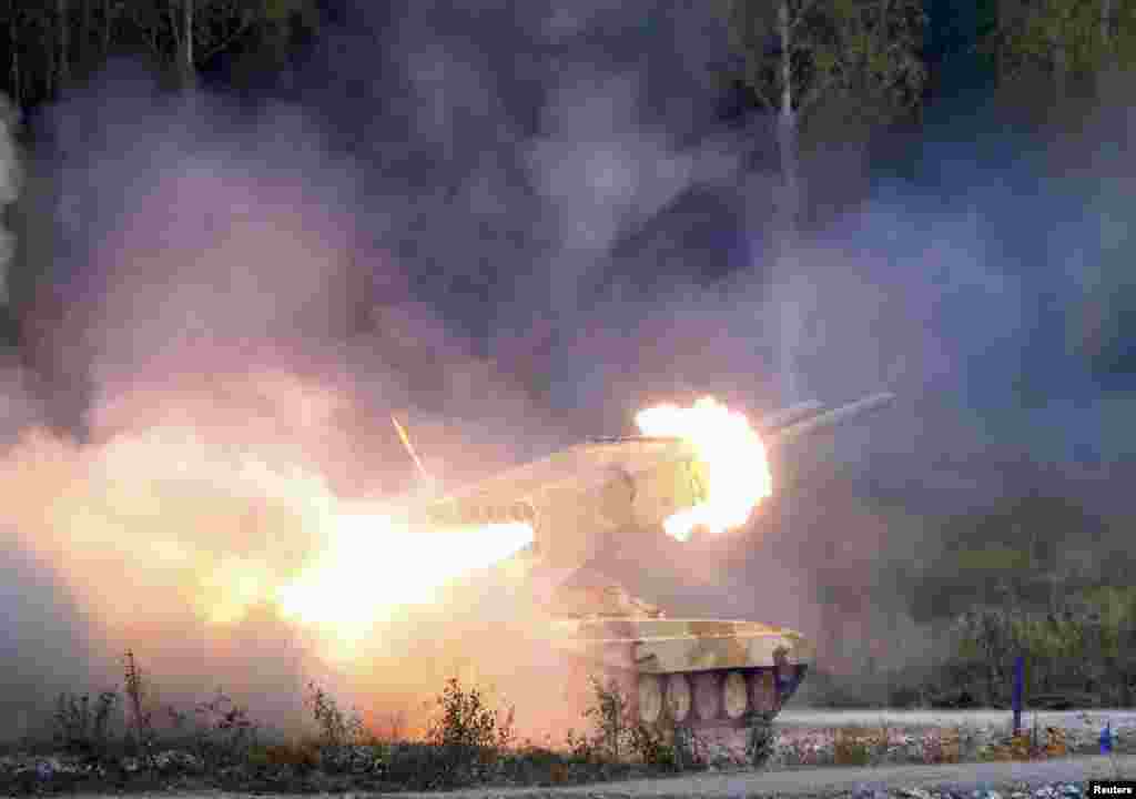 A Russian &quot;TOS-1 Buratino&quot; multiple rocket launcher fires during the &quot;Russia Arms Expo 2013&quot; 9th international exhibition of arms, military equipment and ammunition, in the Urals city of Nizhny Tagil.