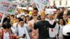 Indonesian President Joko Widodo, center right, walks and his running mate Ma'ruf Amin during a ceremony marking the kick off of the campaign period for next year's election in Jakarta, Sept. 23, 2018. Indonesia is set to hold its presidential and parliamentary election in April 2019.