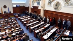 A group of opposition members of VMRO-DPMNE stand to boycott the vote as the Macedonian parliament approves constitutional changes to allow the Balkan country to change its name to the Republic of North Macedonia, in Skopje, Macedonia, Oct. 19, 2018.