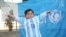 Murtaza Ahmadi posing with a jersey sent to him by Argentine football star Lionel Messi.