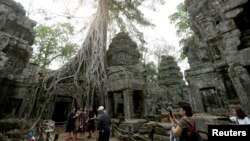 Tourists visit the Ta Prohm temple complex in Siem Reap province, Cambodia, March 16, 2019.