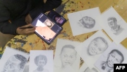 FILE—A member of “Art for Memories” team draws portraits of victims of the Rwandan genocide in Kigali on April 2, 2024.