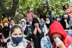 Afghan nationals react at a gathering to urge the international community to help Afghan refugees, in New Delhi, India, August 18, 2021.