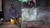 Women sit on the porch in the back courtyard of a house in the Congo Town neighborhood of Sierra Leone's capital Freetown, April 28, 2012. 