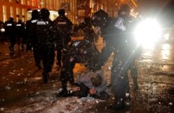 Law enforcement officers detain a man during a rally in support of jailed Russian opposition leader Alexei Navalny in Moscow, Jan. 23, 2021.