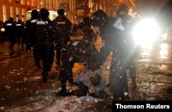 Law enforcement officers detain a man during a rally in support of jailed Russian opposition leader Alexei Navalny in Moscow, Jan. 23, 2021.