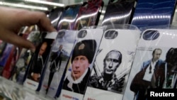 Mobile phones cases displaying images of Russian President Vladimir Putin are displayed at an electronic store in Stavropol in southern Russia, February 12, 2015.