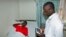 FILE - A doctor talking with a pacient at the Ntinda hospital in Kampala, Uganda.