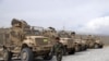 A member of the Afghan security forces walks in the sprawling Bagram air base after the American military departed, in Parwan province north of Kabul, Afghanistan, July 5, 2021. 