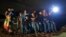 FILE - A group of young migrants from Honduras and El Salvador who crossed the U.S.-Mexico border illegally are stopped in Granjeno, Texas, June 25, 2014.