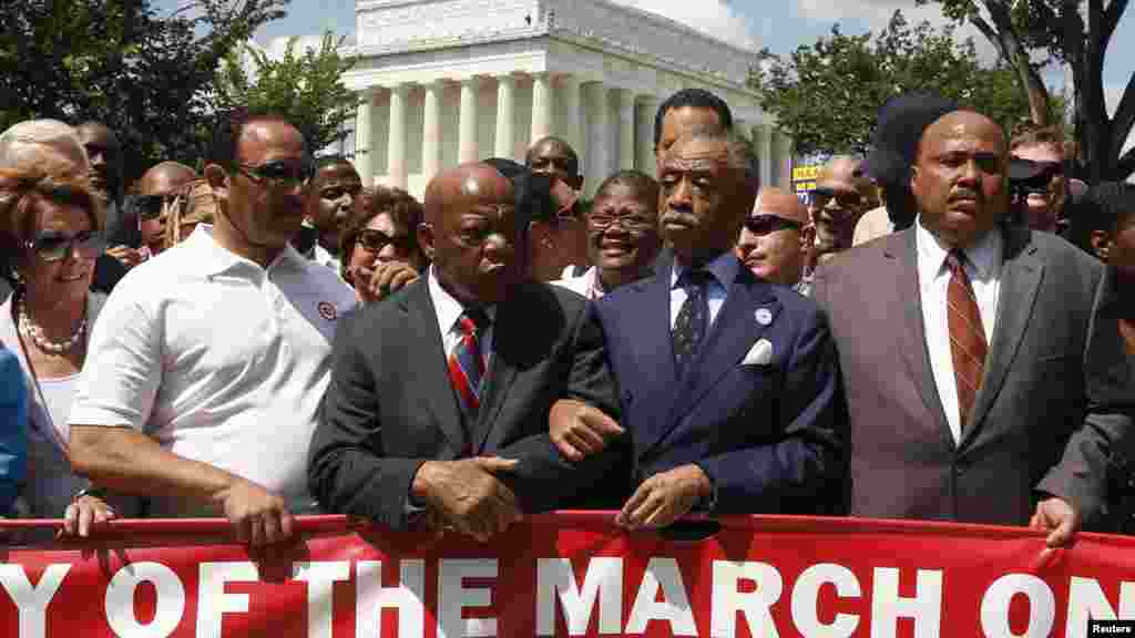 Rev. Al Sharpton (2nd R) links arms with Rep. John Lewis (D-GA) next to Martin Luther King III (R) as they begin to march during the 50th anniversary of the 1963 March on Washington for Jobs and Freedom at the Lincoln Memorial in Washington, Aug. 24, 2013