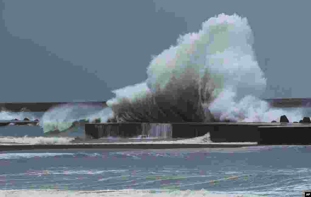 Massive waves from approaching Tropical Storm Trami slam into breakwaters near Toucheng, north eastern Taiwan.