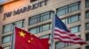 FILE - Chinese and American flags fly outside of a JW Marriott hotel in Beijing, Jan. 11, 2018. 