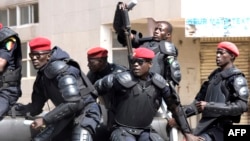 Senegalese policemen patrol during anti-government demonstrations in Dakar on April 19, 2018.