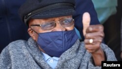 FILE - Archbishop Desmond Tutu gestures after receiving his coronavirus (COVID-19) vaccination in Cape Town, South Africa, May 17, 2021. 